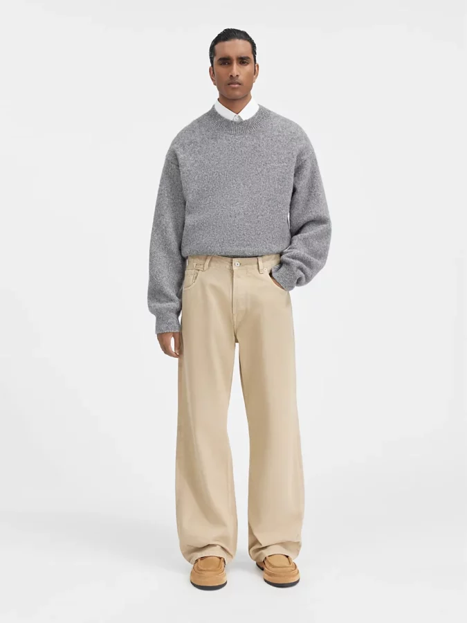 look de suéter gris y pantalones baggy de jacquemus