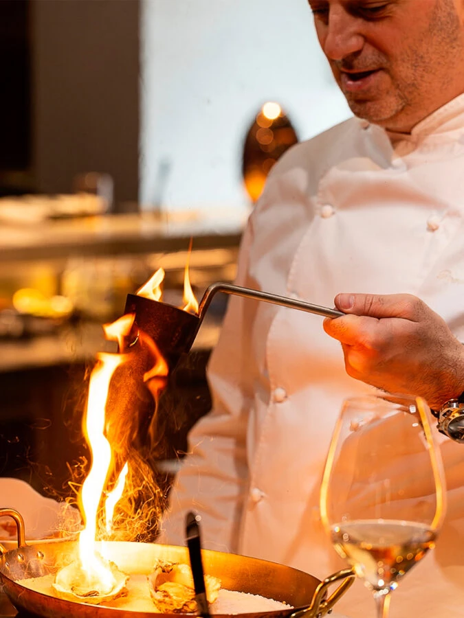 Romain Fornell flameando ostras en la cocina del restaurante Caelis.