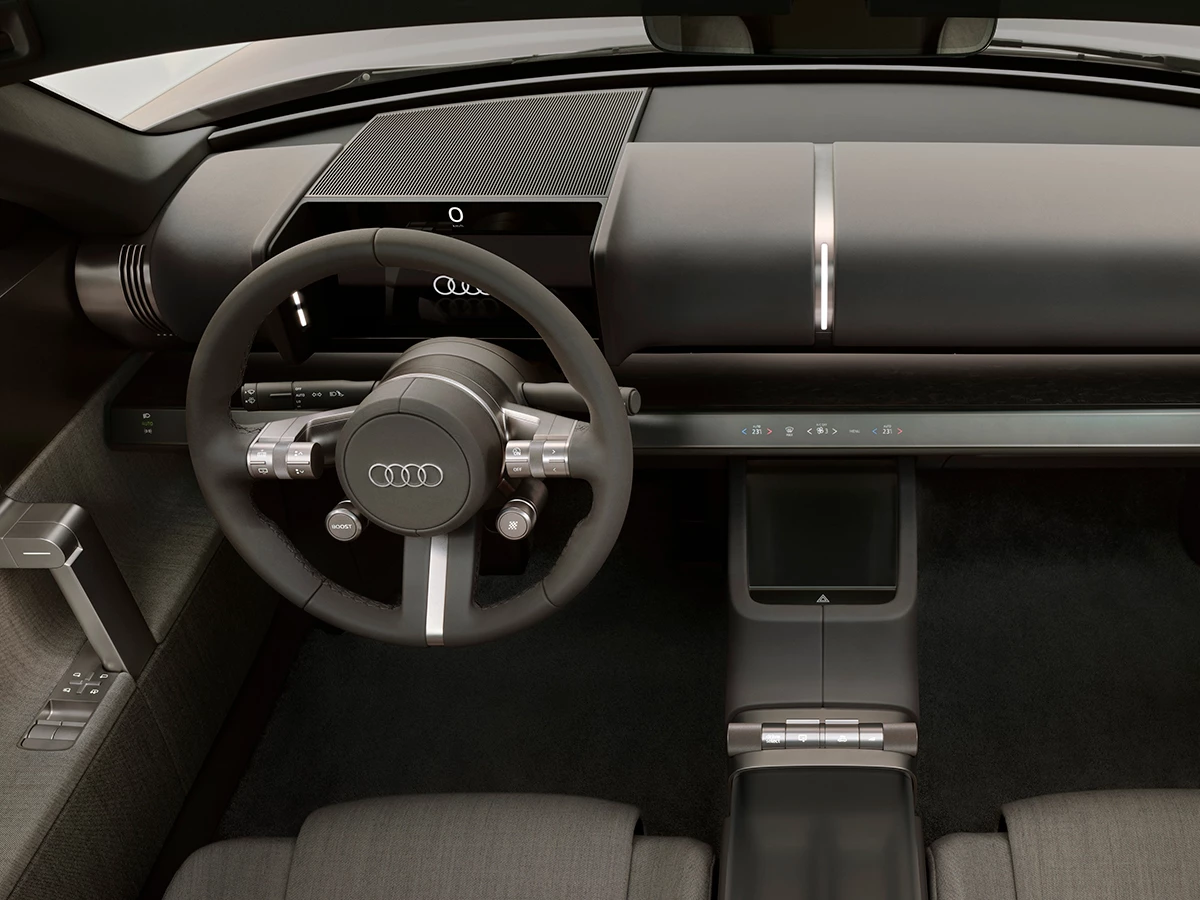 Interior del Audi Concept C con volante minimalista y controles hápticos de aluminio