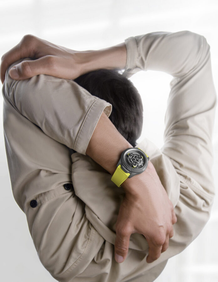 reloj Ulysse Nardin y Urwerk UR-FREAK en la muñeca con correa amarilla