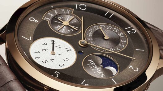 Primer plano del Slim d’Hermès Quantième Perpétuel con esfera marrón galvánico y fases lunares de nácar