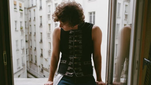 Guitarricadelafuente posando en una ventana de su hotel antes de su concierto en París