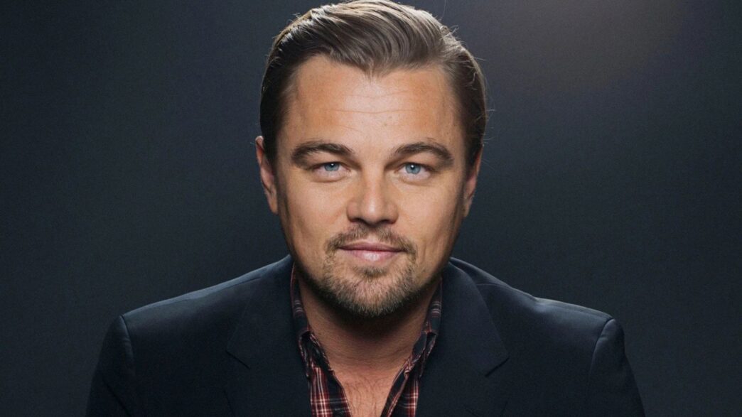 Primer plano del actor Leonardo DiCaprio mirando fíjamente a la cámara con una chaqueta negra.