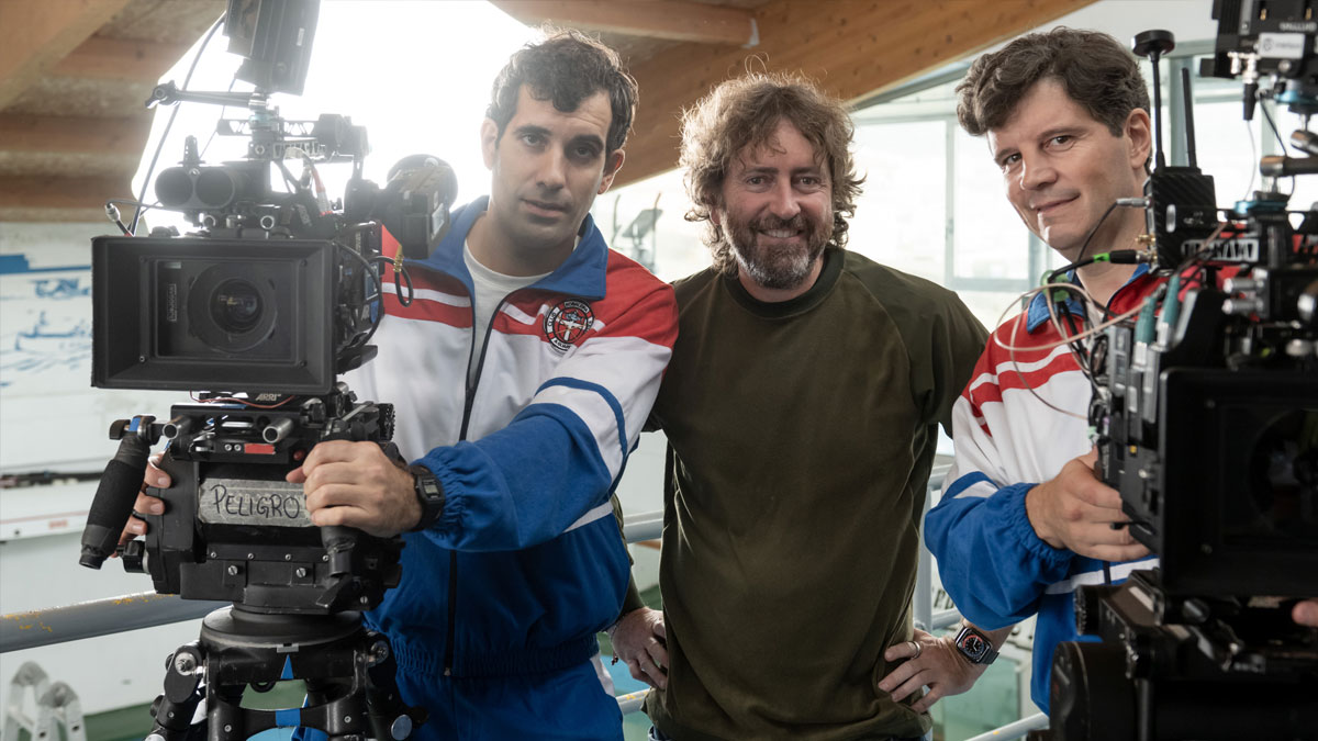 El actor Tamar Novas con chándal blanco, azul y rojo; el director Daniel Sánchez Arévalo con jersey marrón; y el actor Xosé A. Touriñán también con chándal azul, blanco y rojo antes de grabar Rondallas.