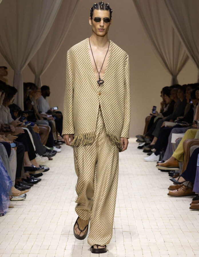 Modelo desfilando en el show de Emporio Armani con un look color arena
