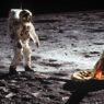 Astronauta del Apolo 11 caminando sobre la superficie lunar junto a la pata dorada del módulo lunar Eagle.