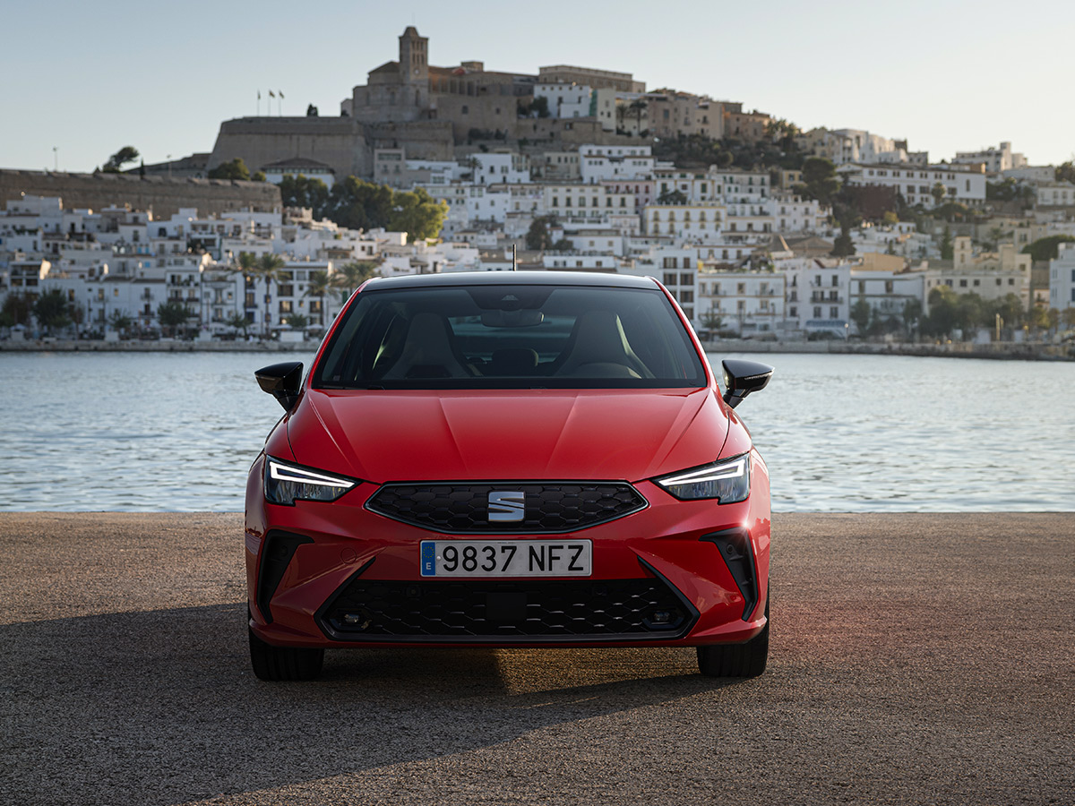 Frontal del SEAT Ibiza 2026 en rojo frente a Dalt Vila, en la isla de Ibiza
