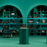 Sala verde de The Watch Keepers de Audemars Piguet con vitrinas de relojes y el logotipo de la plataforma