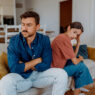 pareja joven enfadados en sofá